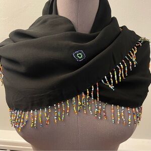 Black triangular wrap with beaded fringe trim and diamond pattern